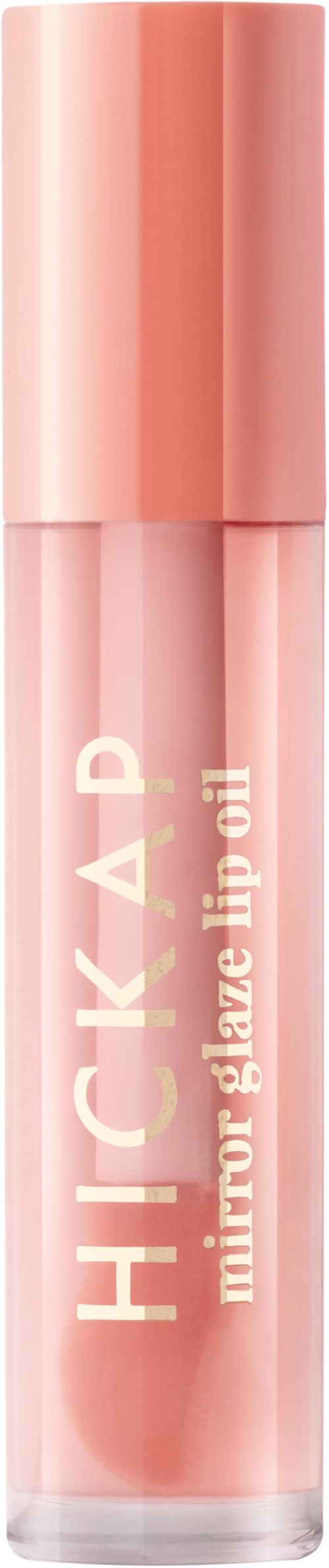 En rosa läppglansrör med en glansig lock, märkt 'HICKHACK mirror glaze lip oil.'
