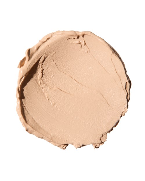 A round, beige-colored blob of cream or foundation on a white background.