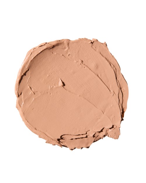 A round of beige cream or makeup with a cracked surface on a white background.