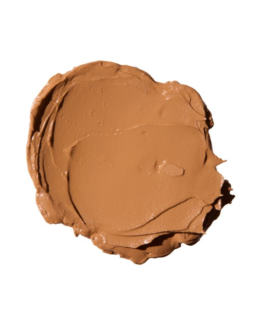A brown, round object with a smooth, creamy surface and some cracks, looks like a cookie or biscuit.