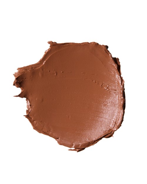 A round, flat, smooth, brown substance, likely chocolate or a similar edible spread.