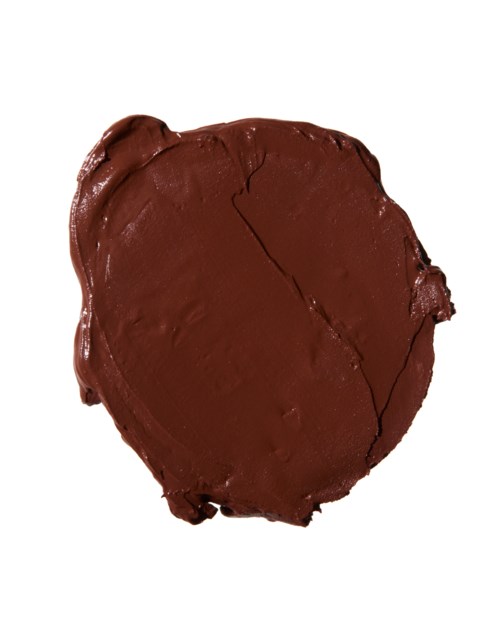 A heart-shaped piece of chocolate with cracks and a glossy surface.