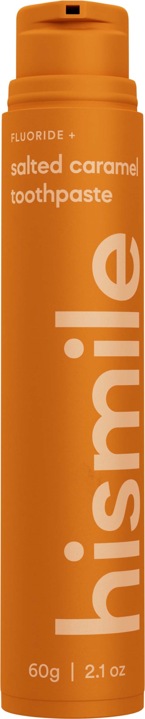 En orange tube tandpasta mærket "salted caramel" med ordet "hismile" skrevet lodret.