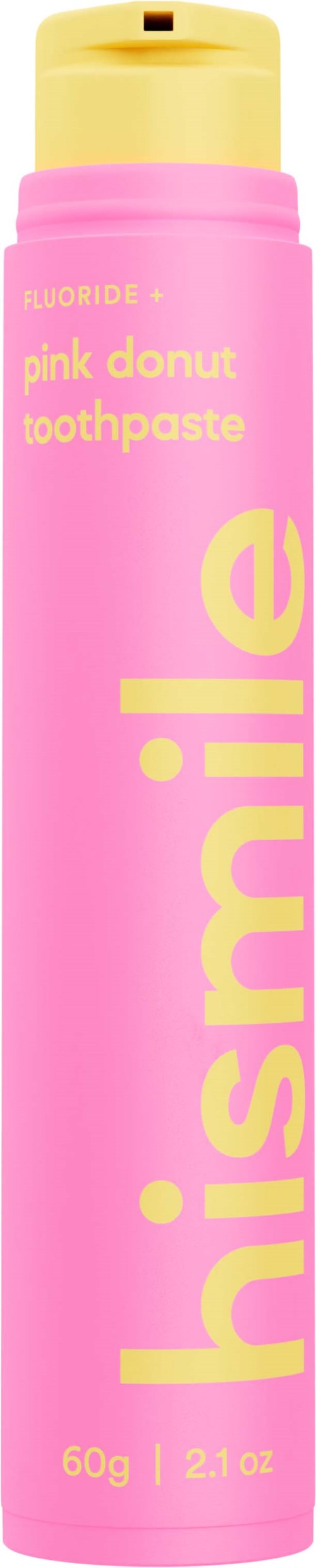 Een roze tandpasta fles met gele dop en tekst, reclame voor 'pink donut toothpaste'.