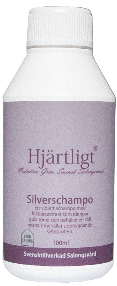 En hvid flaske med lilla etikett, indeholder violet shampoo, mærket "Hjärtligt Silver Shampoo til gråt hår, 100ml."