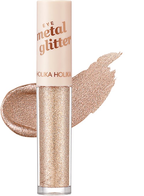 Silmän metallinen glitteri tuubi ja vieressä häivytetty hohtava, kimaltava kulta-beige luomiväri.