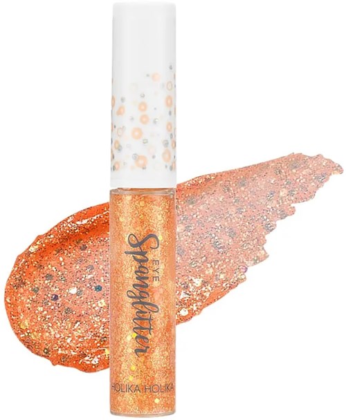  Läppglansrör med glittrande orange färg och vit topp. Glitter sprider sig bakom.