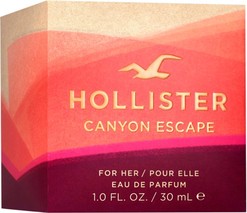 Eine rosa-orangefarbene Schachtel mit Hollister-Logo und Text für ein Parfüm namens Canyon Escape.