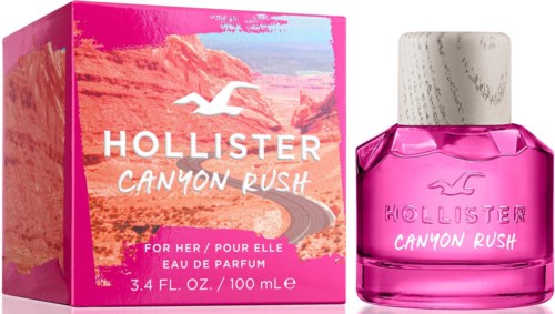 Różowe i białe opakowanie z pejzażem pustynnym, różowa butelka perfum z białym korkiem, logo Hollister i tekst, nazwa produktu.