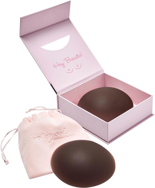 Eine rosa Schachtel mit Nachricht, ein schwarzer ovaler Gegenstand und ein rosa Beutel mit Schnur. Die Box sagt, "Hey Beautiful!".