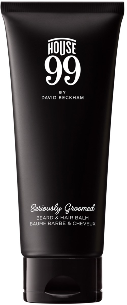 En svart tub med skägg- och hårbalsam med vitt text, kallad House 99 av David Beckham, säger "Seriously Groomed."