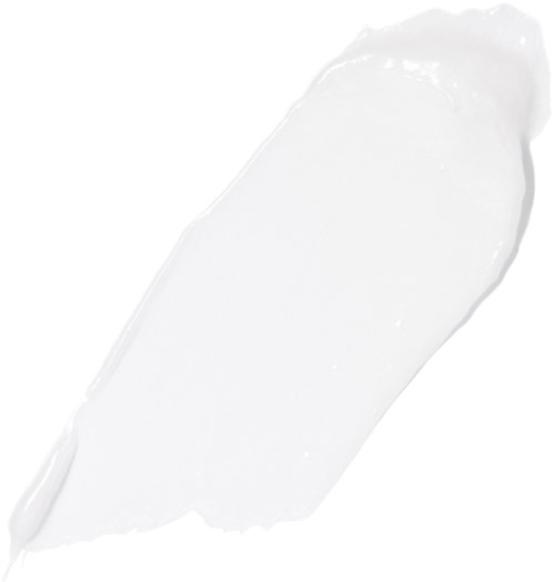 En vit kräm eller lotion är utbredd med en palett på en vit bakgrund.