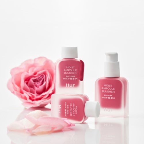 Three pink bottles of blush cream are beside a pink rose and rose petals.
