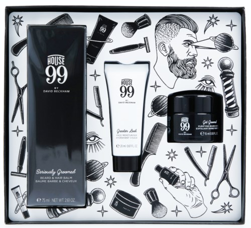 En groomingset med skäggbalsam, hårbalsam och groomingkräm, omgiven av barberarverktyg och konstverk.