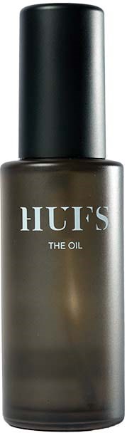 En mørkegrå flaske med sort låg, mærket 'HUF'S THE OIL'. Det ligner en kosmetik- eller hudplejeprodukt beholder.