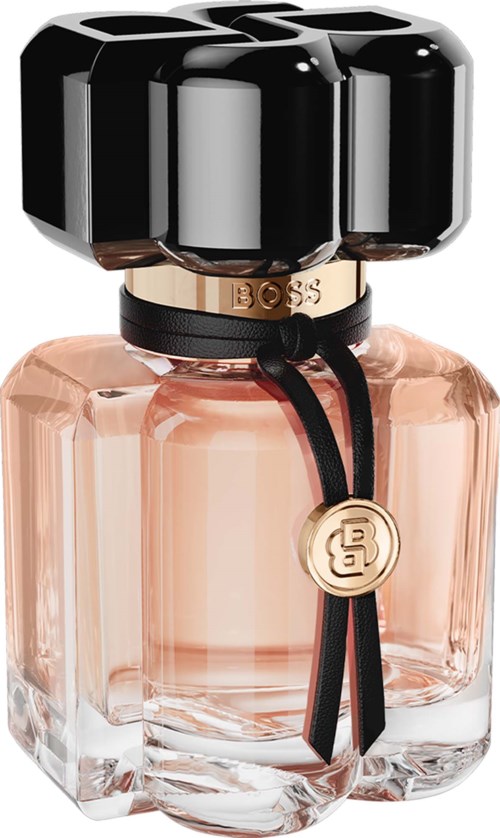 A perfume bottle with a black cap and a gold BOSS logo tag, pinkish liquid inside, elegant cubic glass shape.