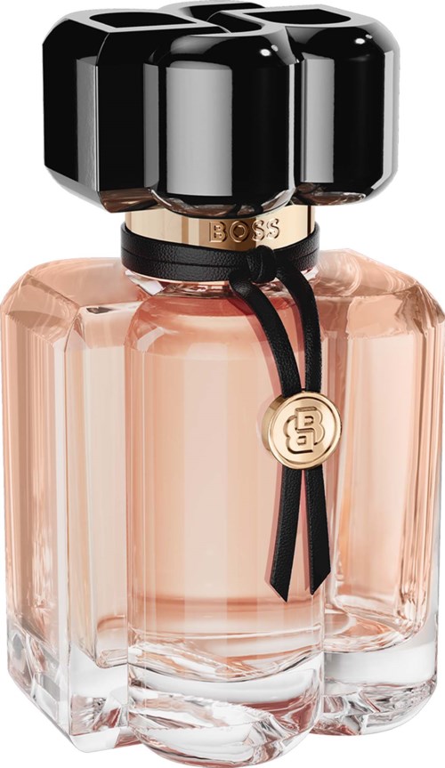Elegant perfume bottle with a large black cap, gold ring detail, and light pink liquid inside.