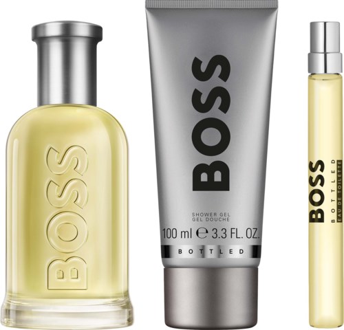 Boss parfumfles, zilveren douchegel tube en kleinere parfum spray met Boss-logo.