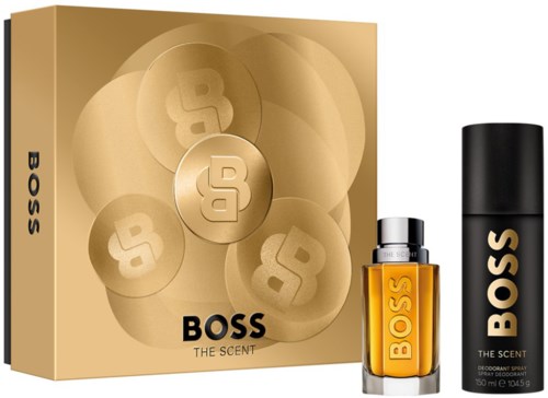 Ett presentset innehåller en stor box, en parfynflaska och en deodorantspray. Förpackningen är guld och svart.