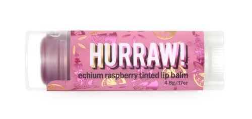 En rosa läppbalsamtube med färgglada frukt- och blomster mönster, märkt 'HURRAW! echium raspberry tinted lip balm.'