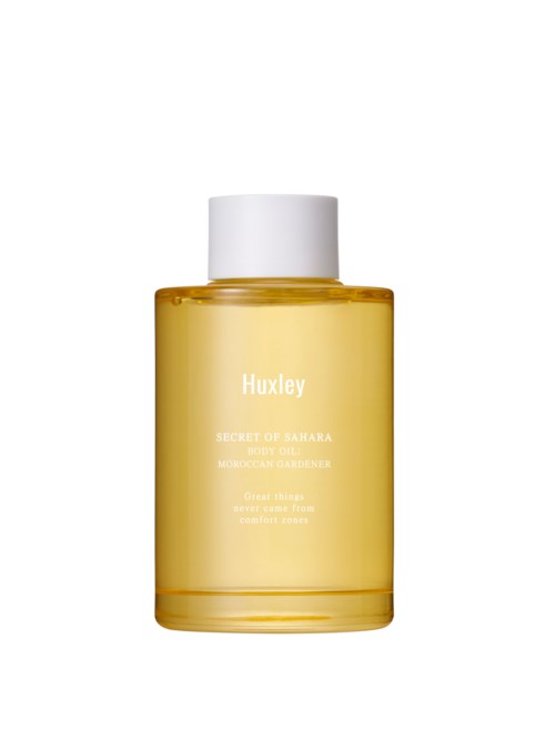 A yellow bottle with white cap and white text, labeled "Huxley" and "Secret of Sahara" skincare product.