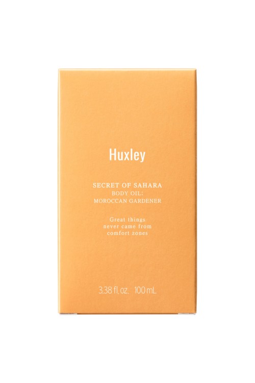 A beige box with white text about Huxley's body oil, named 'Secret of Sahara'.