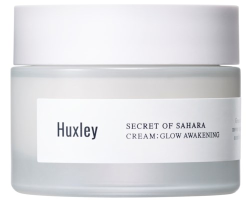 En vit burk med en etikett som säger "Huxley SECRET OF SAHARA CREAM; GLOW AWAKENING."