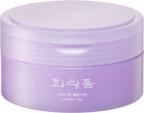 Pyöreä violetti rasia, jossa on koreankielistä tekstiä. Se näyttää kosmetiikka- tai ihonhoitotuotteelta.