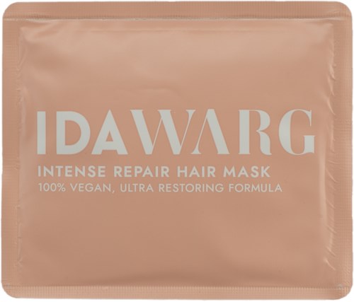 En lysende rosa pakke med hvit tekst som promoterer en intens hårreparasjonsmaske, vegansk og restaurerende.