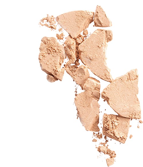 Broken beige powder scattered on a white background.