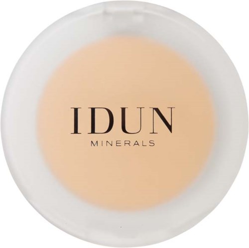 Een wit bord met beige poeder en zwarte tekst: 'IDUN MINERALS'.