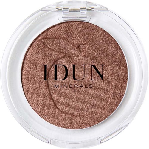 A round compact with brownish-peach powdered makeup, decorated with a simple line drawing of an apple and the text 'IDUN MINERALS.'