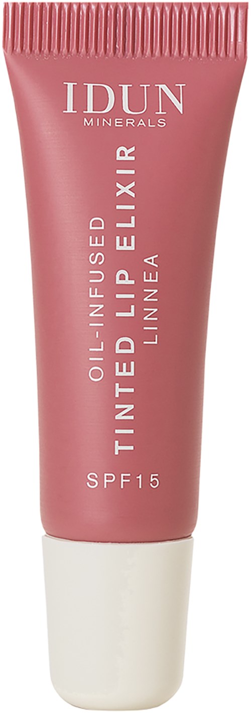 Różowa tubka IDUN Minerals balsamu do ust z SPF 15, nazwana Finte Lip Elixir, stoi pionowo na zdjęciu.