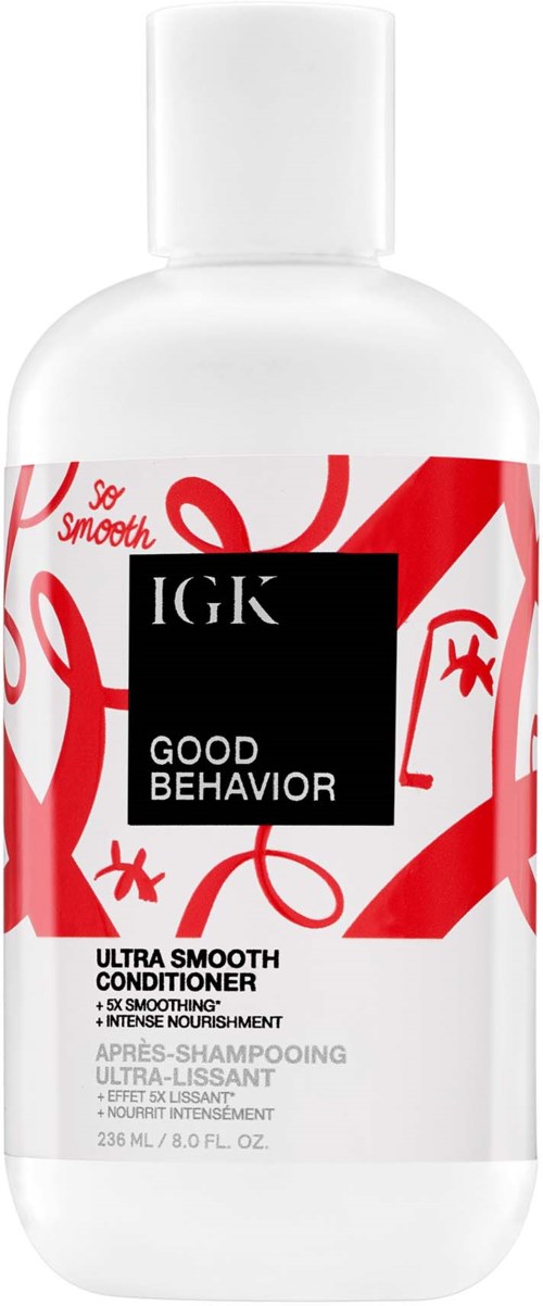 En vit flaska med IGK Good Behavior balsam med röda abstrakta linjer och svart text.