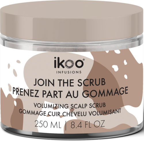 A jar of scalp scrub with beige lid, beige and white label, and black and brown text.