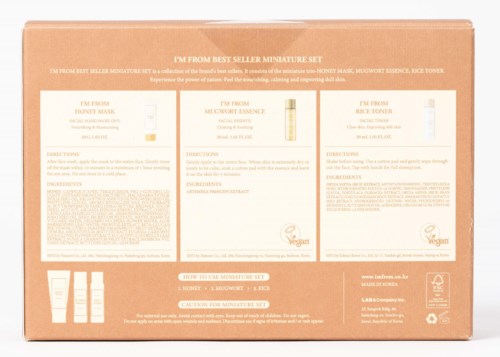 A skincare set with three products: honey mask, moisturizer essence, and night toner, on a peach box background.