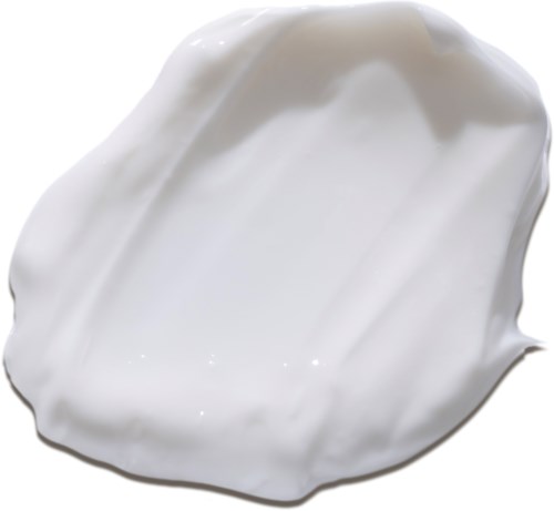 En hvit, kremaktig substans med jevn tekstur og skinnende overflate, kanskje en lotion eller såpe.