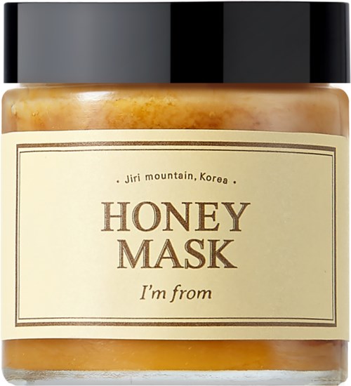 A jar with a black lid, containing honey mask with a beige label that says 'Honey Mask, I'm from'.