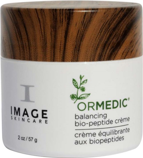 A white jar with a wooden lid, labeled 'ORMEDIC balancing bio-peptide crème' from IMAGe SKINCARE, size 2 oz.