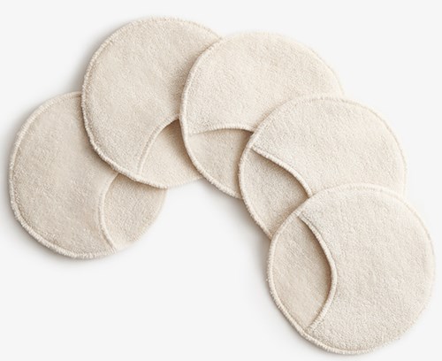 Six round, beige cotton pads arranged on a white background.