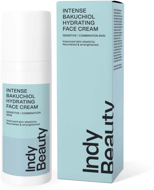 En flaska och förpackning av dagkräm från Indy Beauty för känslig hud, med ljusblå förpackning och svart text.