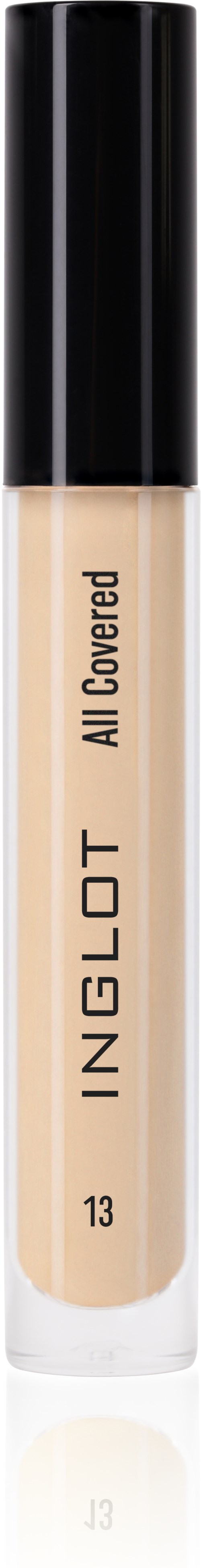 A tube of liquid concealer with a black cap and beige color of the product inside.