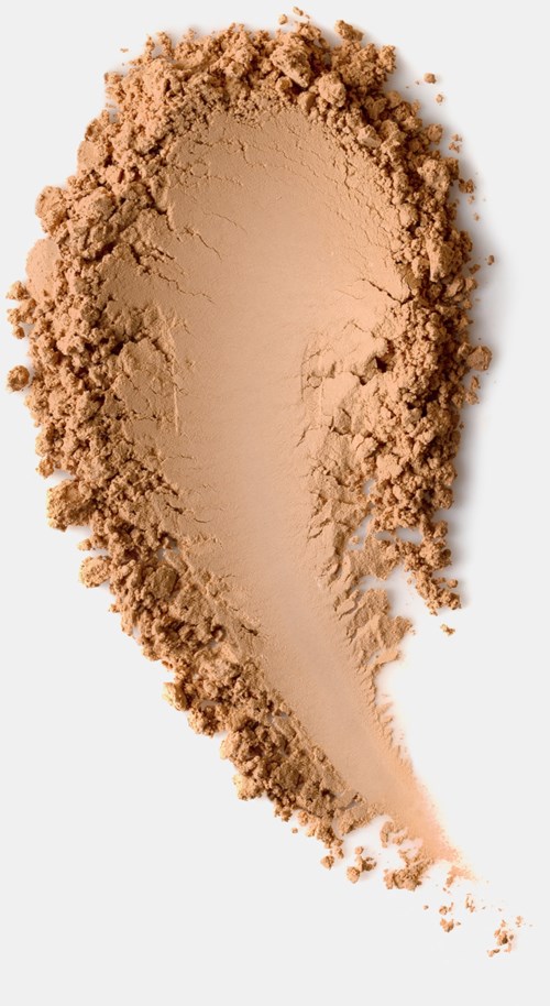 Light brown powder spread in a tear shape on a white background.