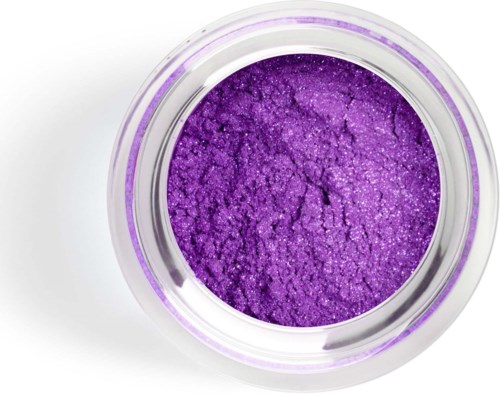 A small round jar filled with bright purple, sparkling powder. It is turned upside down, showing the inside clearly.