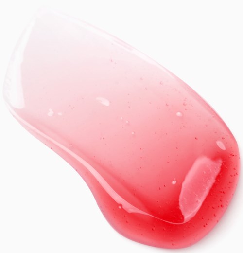 En rosa geléliknande substans på en vit yta, med en transparent, kurvig form och små bubblor inuti.