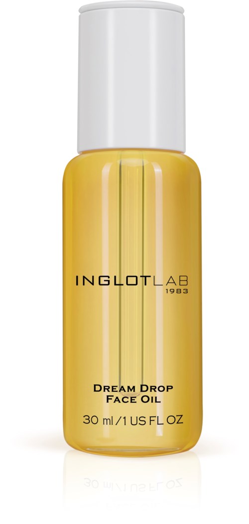 En liten gul flaska med ansiktsolja och vit kork, märkt 'Dream Drop Face Oil' och 'Inglot AB 1983'.