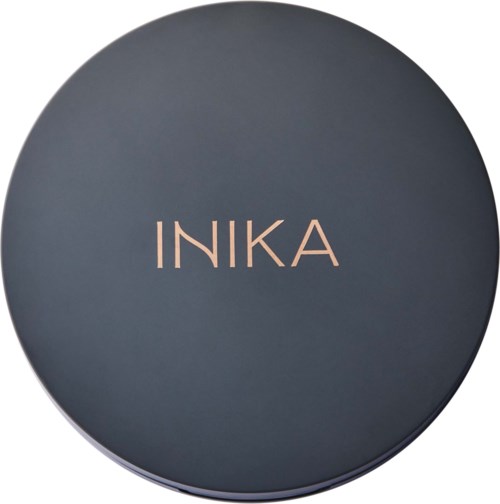 En rund, mörkfärgad behållare med ordet 'INIKA' i ljus färg på locket.