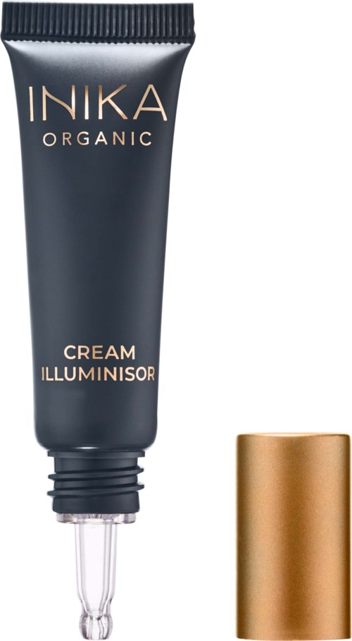 Ein dunkler Tube mit der Aufschrift 'INIKA ORGANIC CREAM ILLUMINATOR' und einem goldenen Deckel daneben.