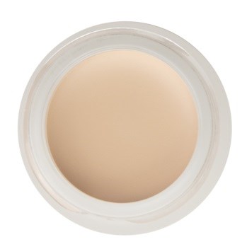 En liten, rund behållare med beige kräm inuti, sett ovanifrån.