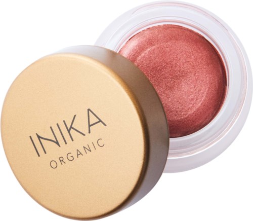 Ein runder Behälter mit rosa farbener Creme-Foundation und beige Deckel, beschriftet mit 'INKA ORGANIC'.
